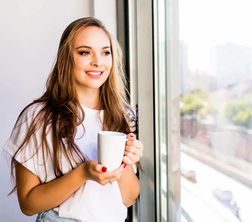 woman enjoying coffee and sunrise feeling free after depression treatment in washington dc